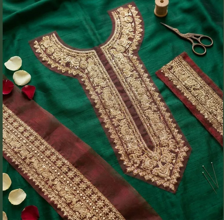Editorial hero flat-lay: gold zari on emerald silk with styled props