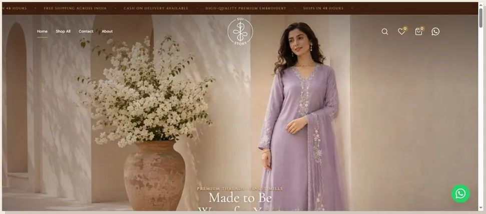 Live storefront hero: a model in lilac embroidery against a sunlit courtyard, with the announcement bar running shipping and COD promises above the nav